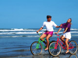 Middle-aged Couple Riding Bikes on the Beach