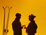 Silhouette of Middle-Aged Couple with Ski Gear Relaxing with Wine