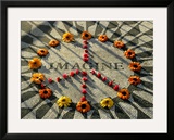 A Makeshift Peace Sign of Flowers Lies on Top John Lennon's Strawberry Fields Memorial