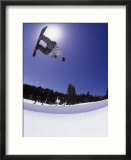 Airborne snowboarder in half pipe position