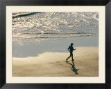 A jogger runs along the beach