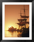 Sydney Opera House and the HMS Bounty  a replica of the famous ship  silhouetted by the setting sun