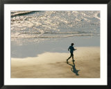 A jogger runs along the beach