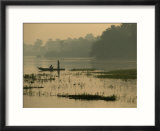 Fishermen drift along the bank of the Nile as twilight falls