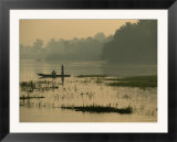 Fishermen drift along the bank of the Nile as twilight falls