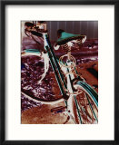 A cyan bike against a bright red background