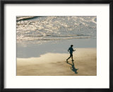 A jogger runs along the beach