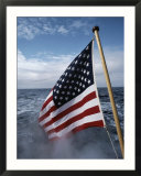 An American flag flutters from the back of a boat in Neah Bay