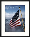 An American flag flutters from the back of a boat in Neah Bay