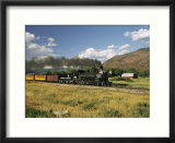 Old Locomotive with Billowing Black Smoke in Hilly Countryside