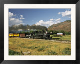 Old Locomotive with Billowing Black Smoke in Hilly Countryside