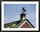 A Flying Pig Weather Vane on a Roof Top