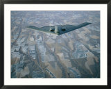 A B-2 Stealth bomber flies above the patterned terrain of southwestern Nebraska