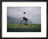 A man pedals an old-fashioned bicycle ahead of an Indiana thunderstorm