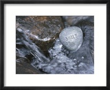 Rock with the Word Smile in Rushing Water
