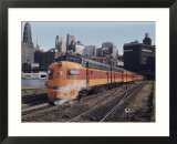 A train on the tracks with the Chicago skyline in the background