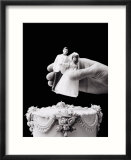 Female hand holding wedding cake topper