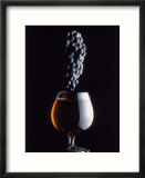 Bunch of Grapes Over a Glass of Wine