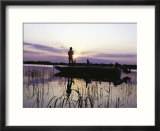 Man Standing In Boat Fishing