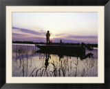 Man Standing In Boat Fishing