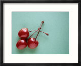 Three Cherries on a Green Background