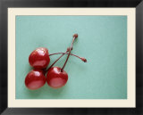 Three Cherries on a Green Background