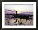 Man Standing In Boat Fishing