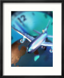 Model jet over glass globe with clock behind