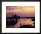 Fishing boat silhouetted at twilight