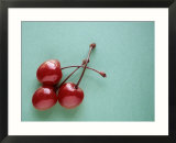 Three Cherries on a Green Background