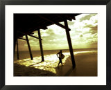 Surfer Walking along Tide
