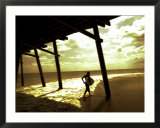 Surfer Walking along Tide