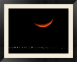 A Crescent Moon Dwarfs the Lights of Fort Riley Army Base in Central Kansas  January 22  2007