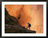 A hiker walks through a canyon at Grandstaircase Escalante National Monument