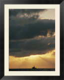 The sun shines through the clouds over the Atlantic ocean