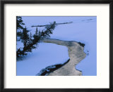 A twilight view of Baronette Creek winding through a snowy landscape