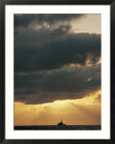 The sun shines through the clouds over the Atlantic ocean