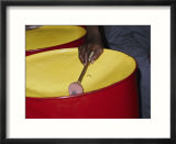 An island musician plays a brightly colored set of steel drums