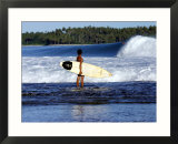 Young Local Boy on Reef Heading out for Afternoon Surf  Lagundri Bay  Indonesia