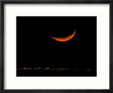 A Crescent Moon Dwarfs the Lights of Fort Riley Army Base in Central Kansas  January 22  2007