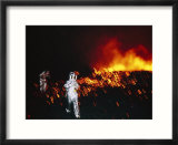 Climbers in Protective Clothing Move Away from the Lava Lake