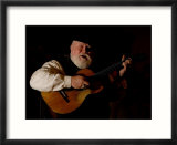 A Cowboy Sings Along to the Song His Guitar is Playing
