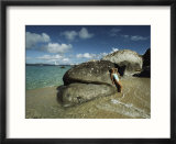 Young Woman Resting against a Rock on a Pristine Beach