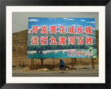 A Bicyclist Rides Past a Billboard