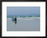 A Fisherman Waits for Help to Bring His Boat Back up to the Beach