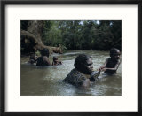 Aborigine Mothers and Children Cool off During a Swim in a River