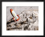 Astronaut Figurines Standing Beside Toy Rocket