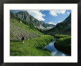 Hiker along a Stream in a Beartooth Mountains Valley