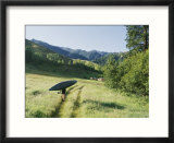 A woman portages a kayak along a trail