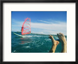The feet of a windsurfer in the water